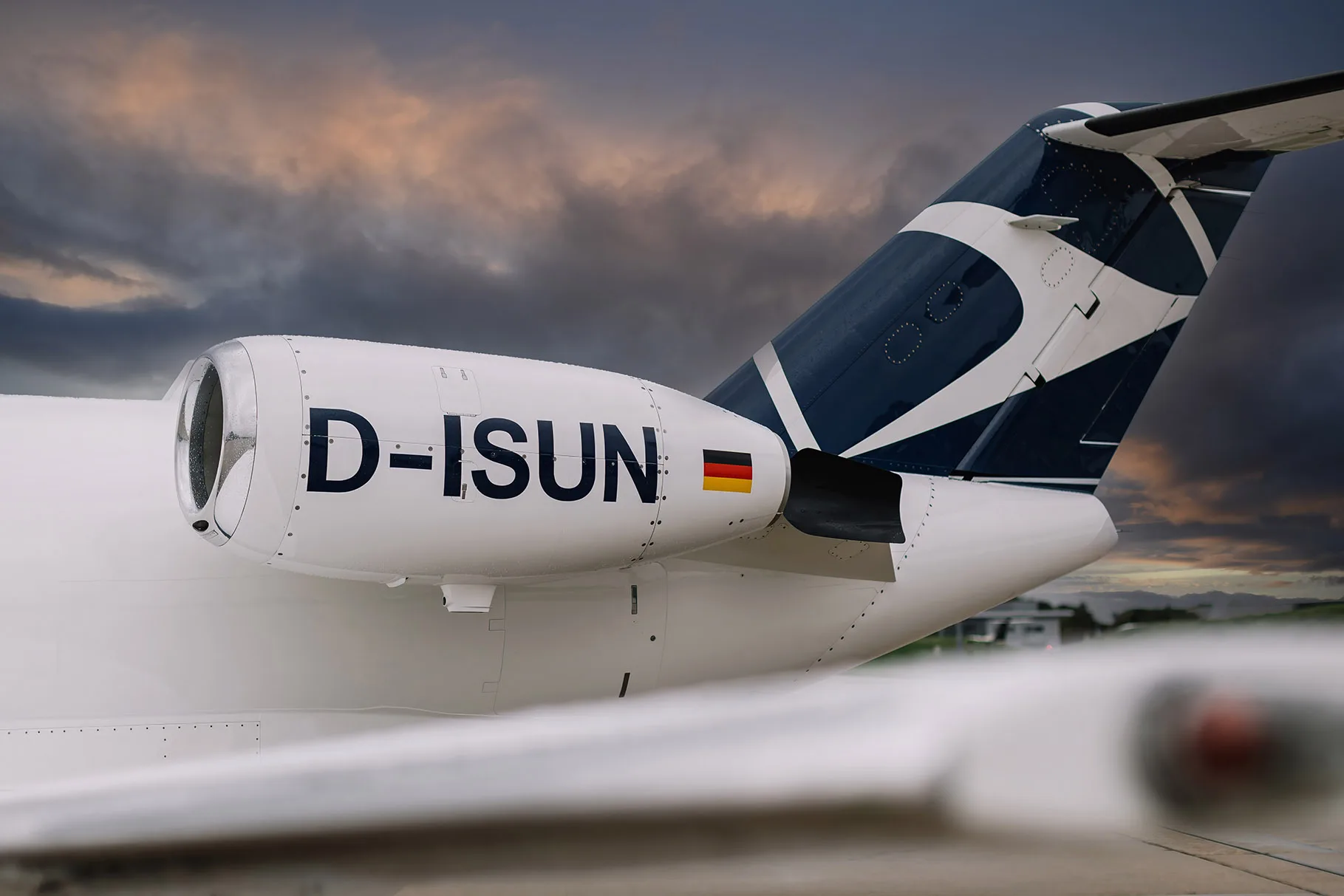 Close-up of the tail and engine of a Cessna Citation CJ2 aircraft with registration D-ISUN.