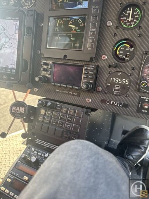 Close-up of the helicopter instrument panel, showing various gauges and controls.
