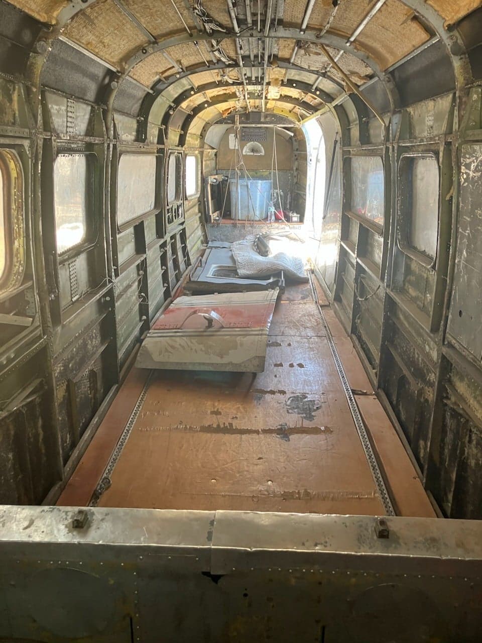 View of the interior of the Twin Bonanza, showing the bare frame and floorboards.