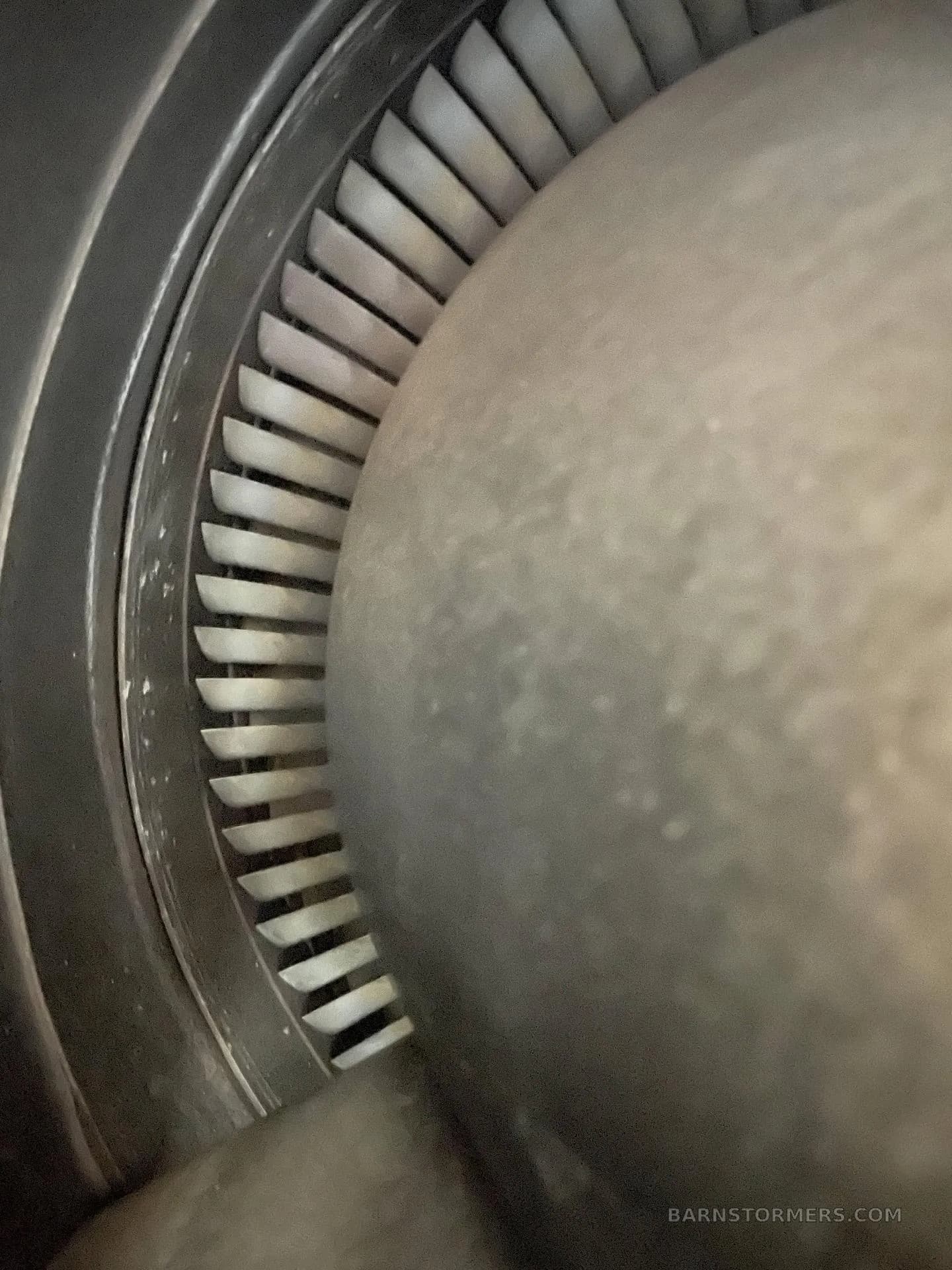 A close-up view of the turbine blades inside a jet engine.