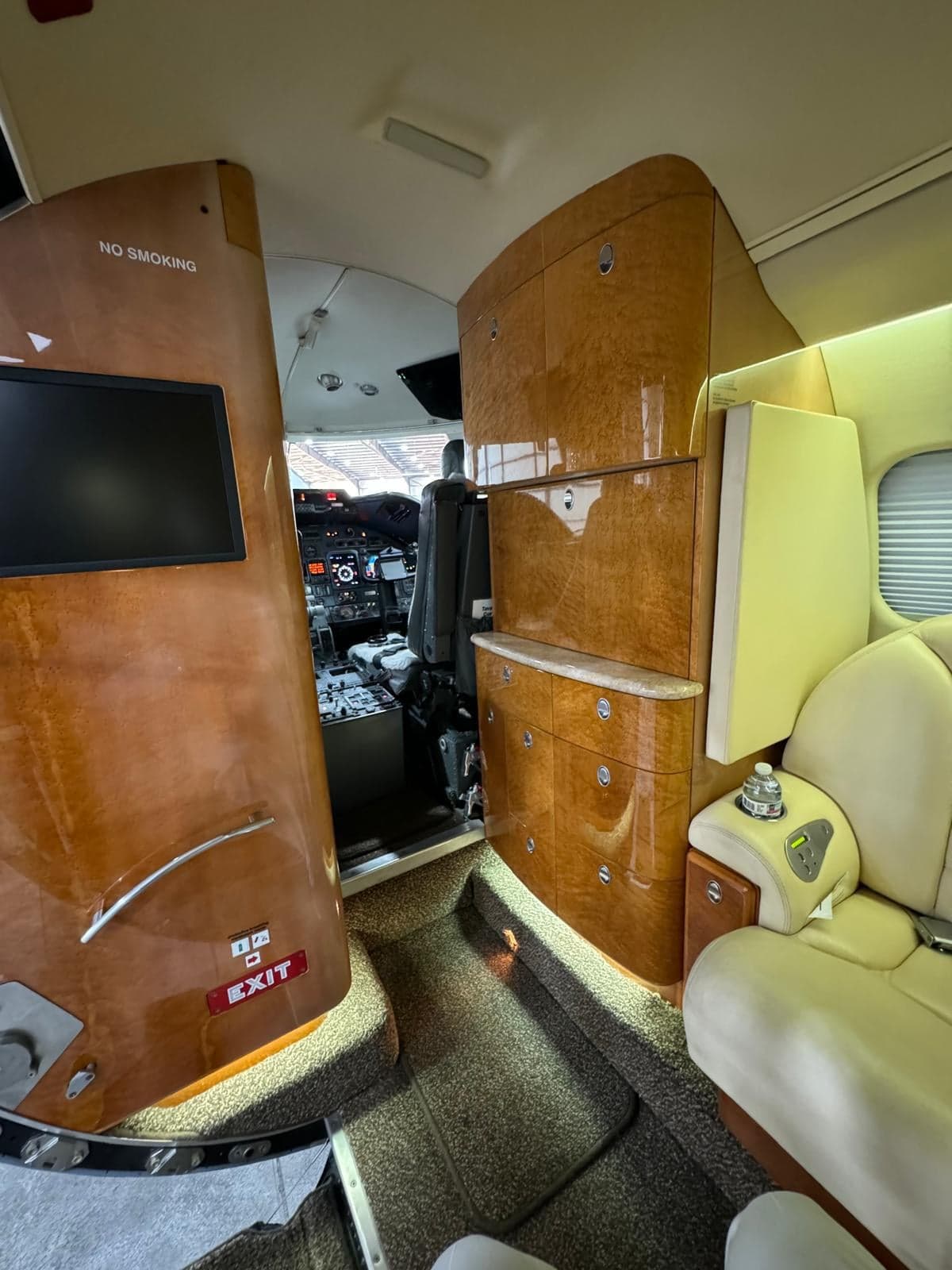 View from the cabin looking towards the cockpit, showing the interior cabinetry and seating.