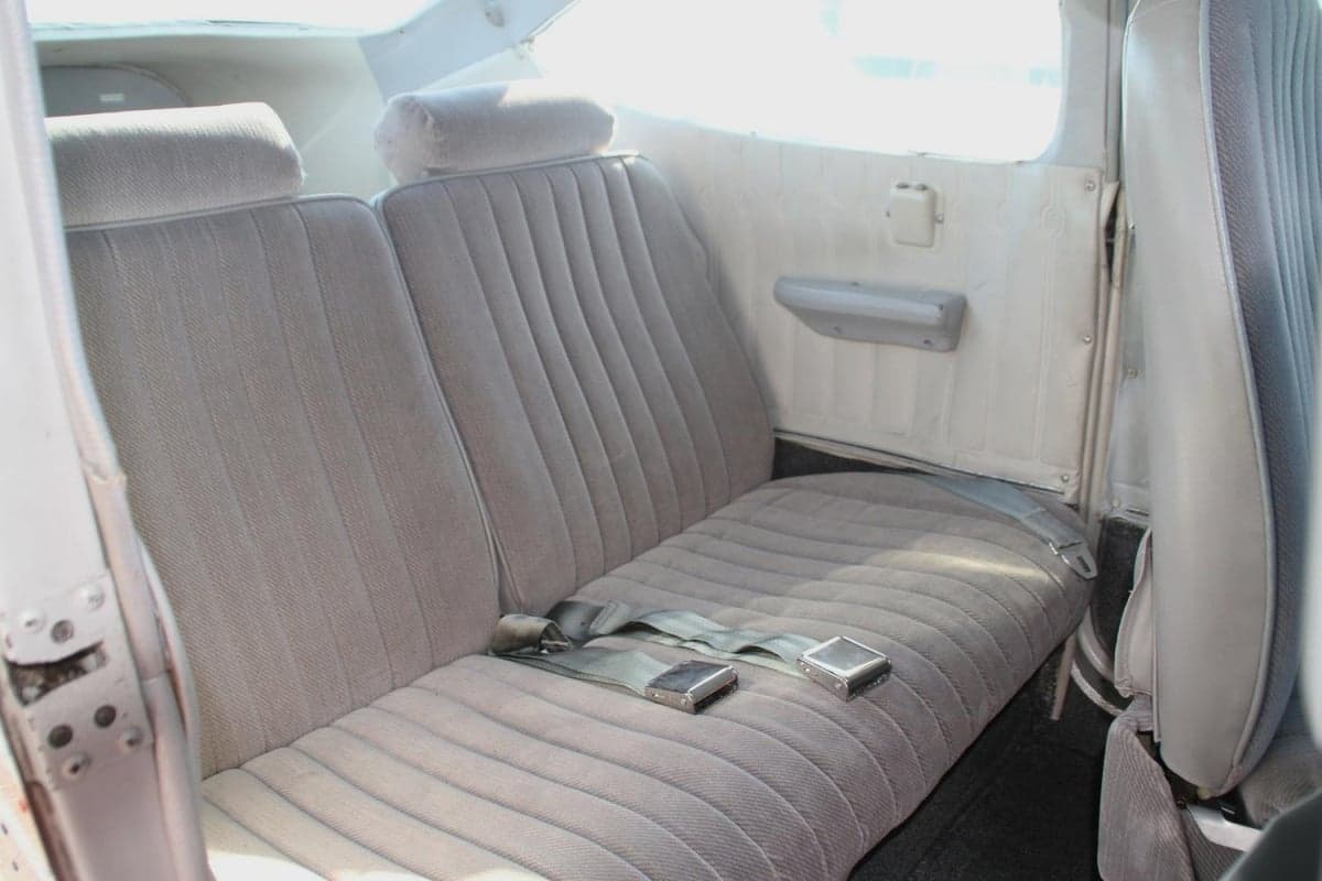A view of the aircraft's interior showing the rear seats with gray upholstery.