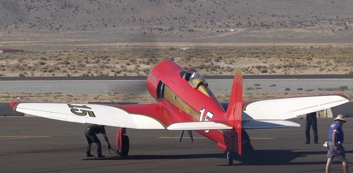 Rear view of a red and gold Furias aircraft with the number 15 on the side.