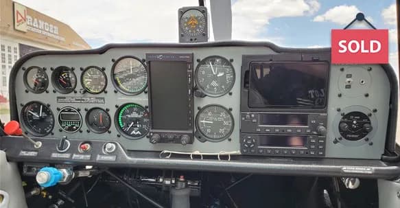 Close-up of the aircraft's instrument panel with various gauges and displays.