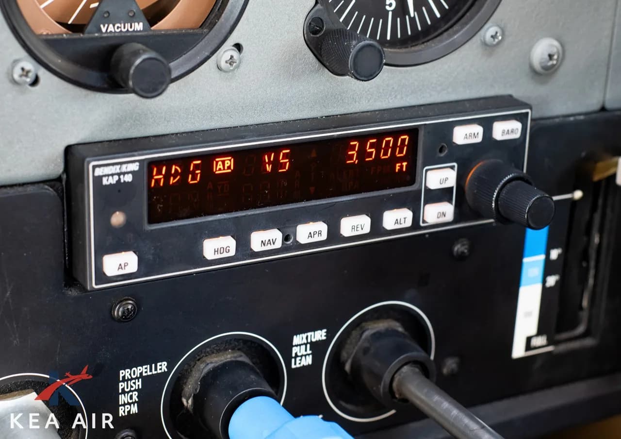 Close-up of the Bendix/King KAP 140 autopilot control panel in the cockpit.