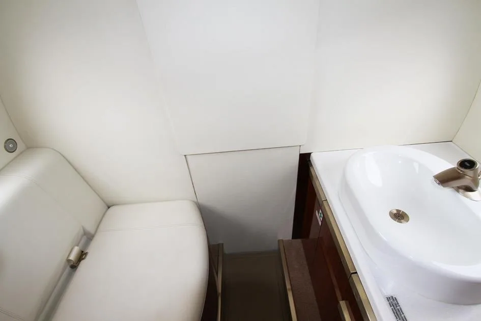 The Phenom 300E cabin features a lavatory with a sink and toilet.