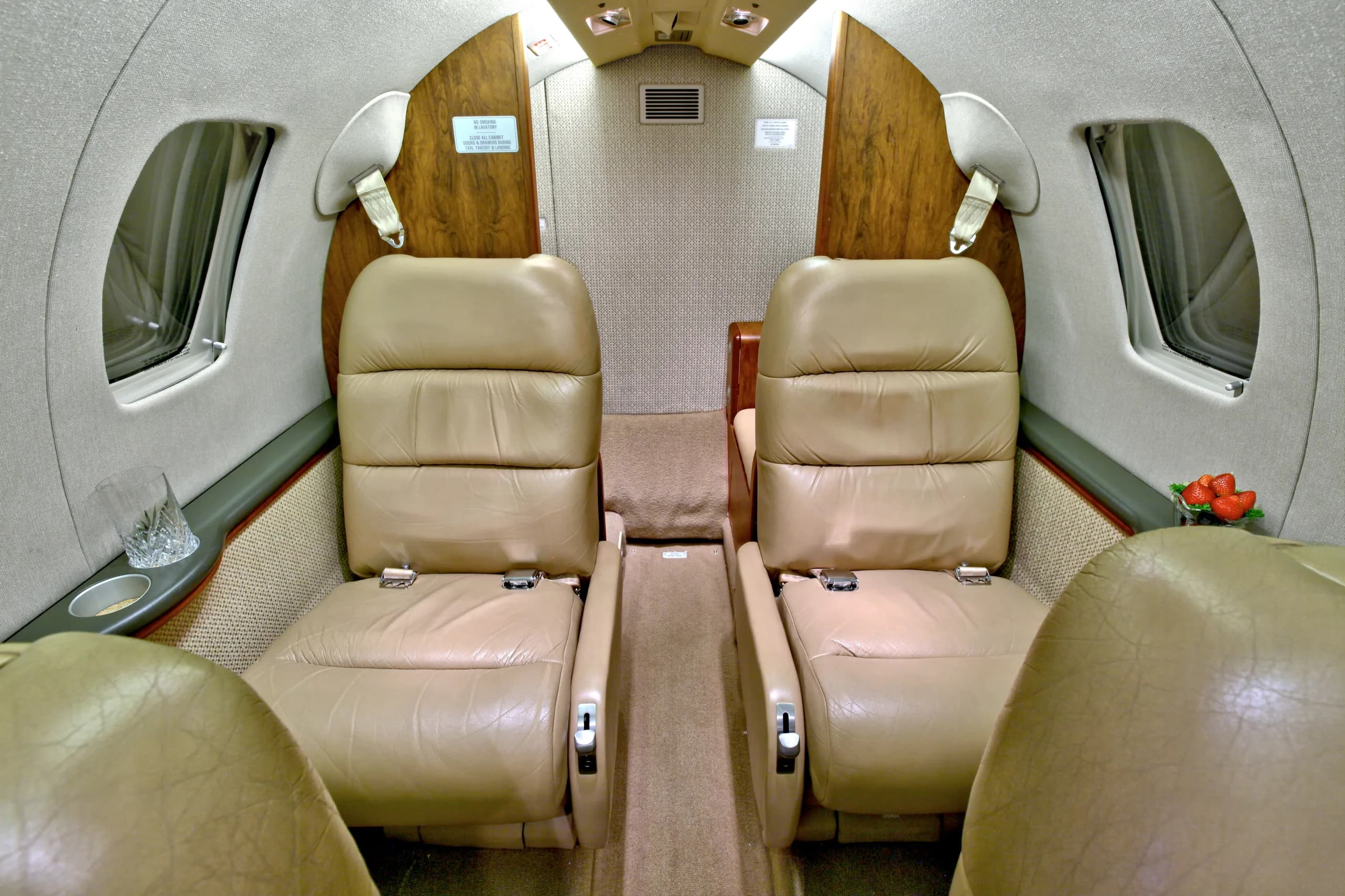 The interior of a Cessna Citation CJ1+ featuring leather seats and a center aisle.