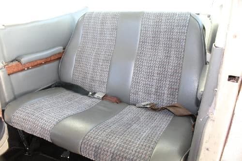Rear bench seat with gray fabric and leatherette trim.