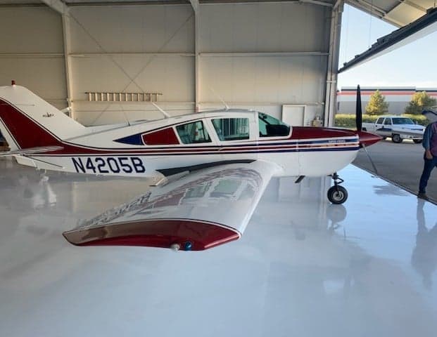 Side view of N4205B aircraft in a hangar.
