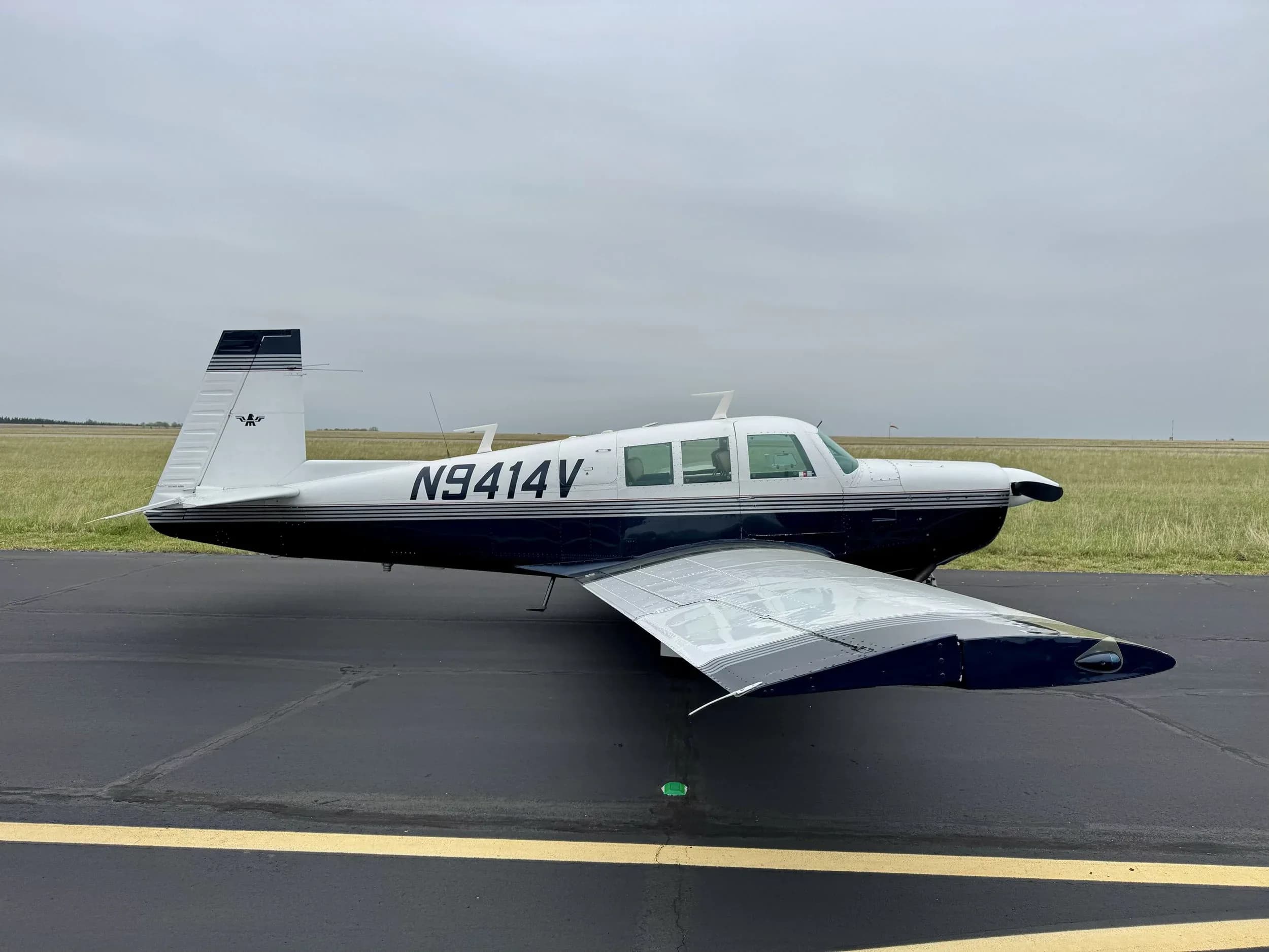 A Beechcraft Bonanza aircraft with registration N9414V is parked on the tarmac.