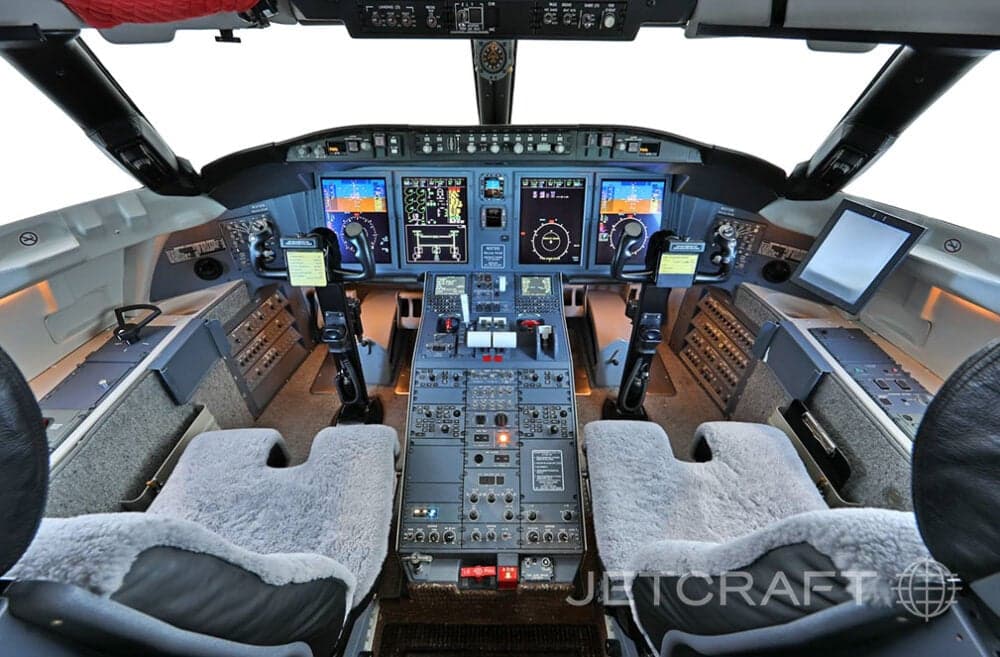 View of the aircraft cockpit with instrument panel and seats.