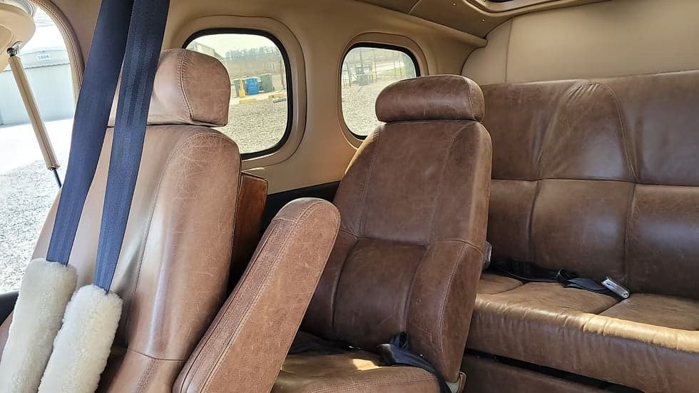 Rear leather seats inside the N210NL aircraft.