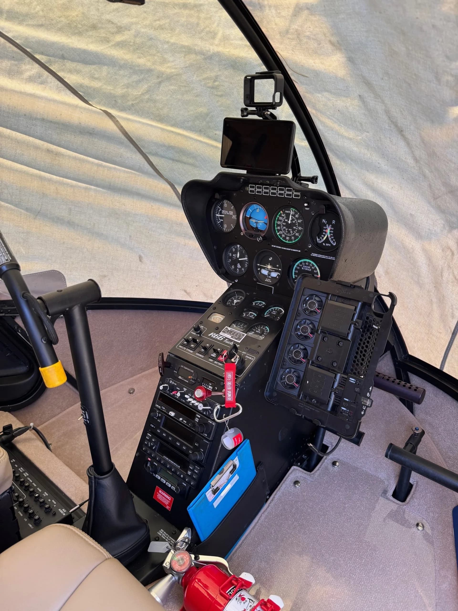 Robinson helicopter cockpit with instrument panel and seats.