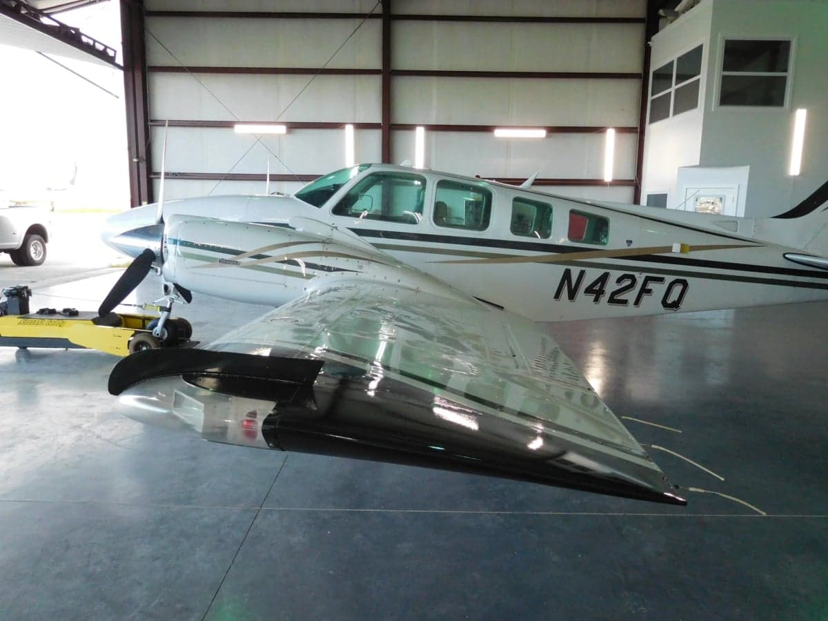 Close-up of the wing and fuselage of the Beechcraft Baron N42FQ.