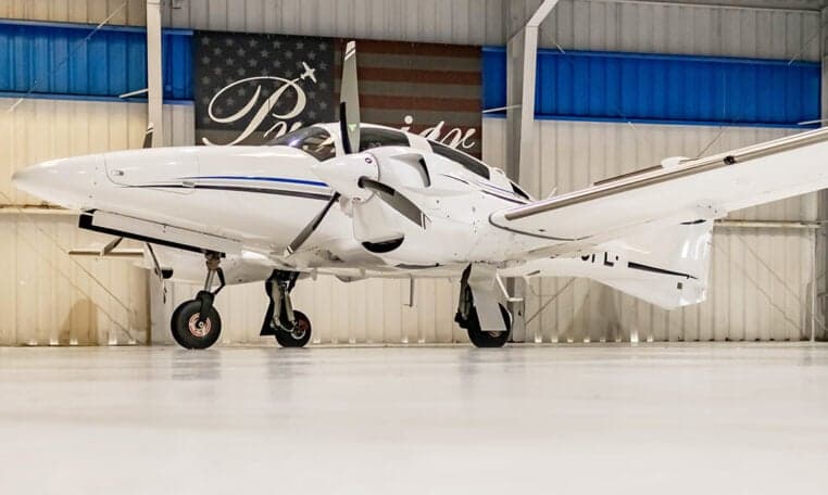 A low angle view of a Diamond DA62 aircraft parked in a hangar.