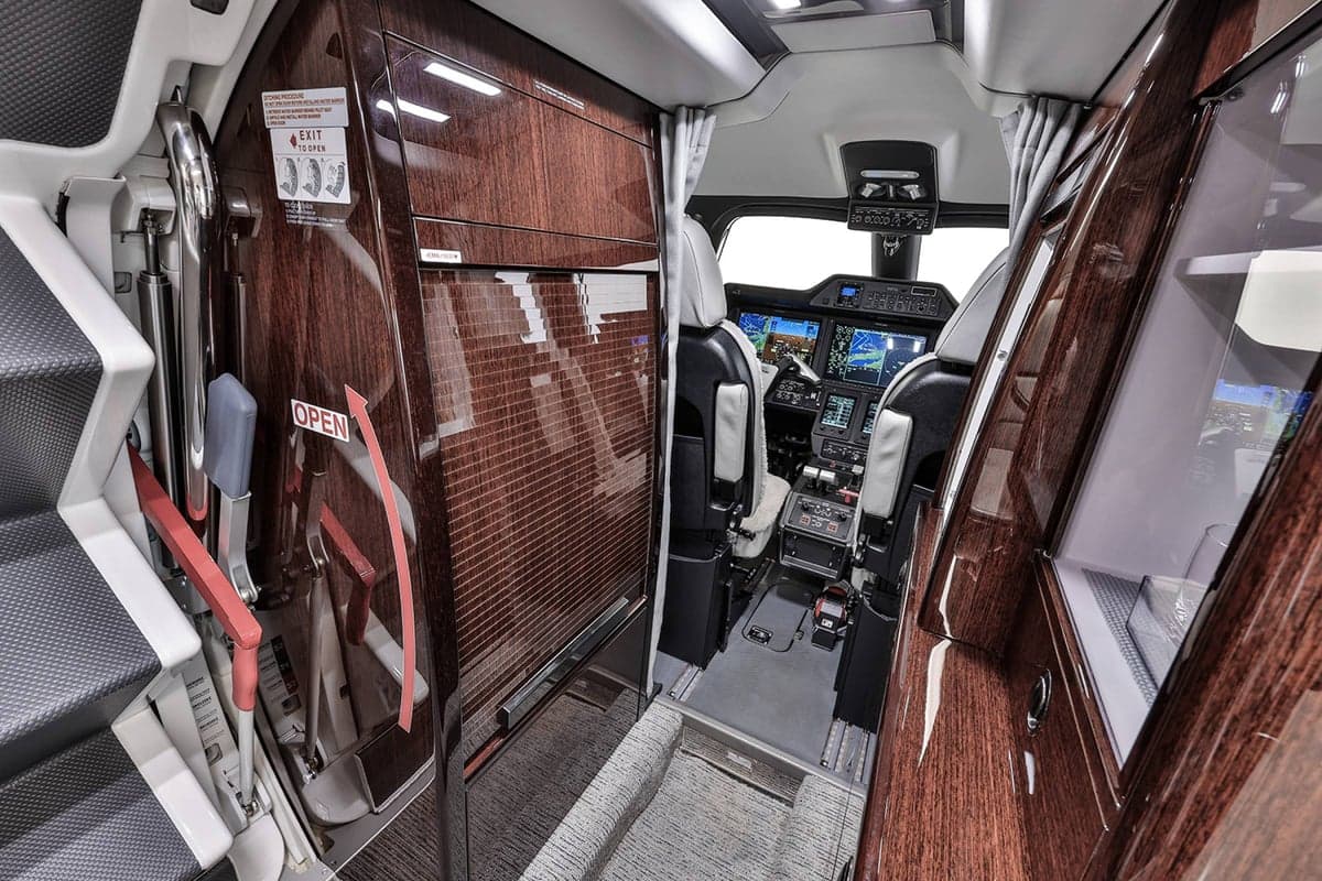 View of the Phenom 300E cockpit from the cabin entrance.