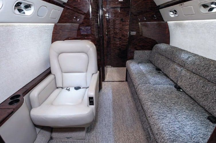 Interior view of the aircraft with a single seat and a couch.