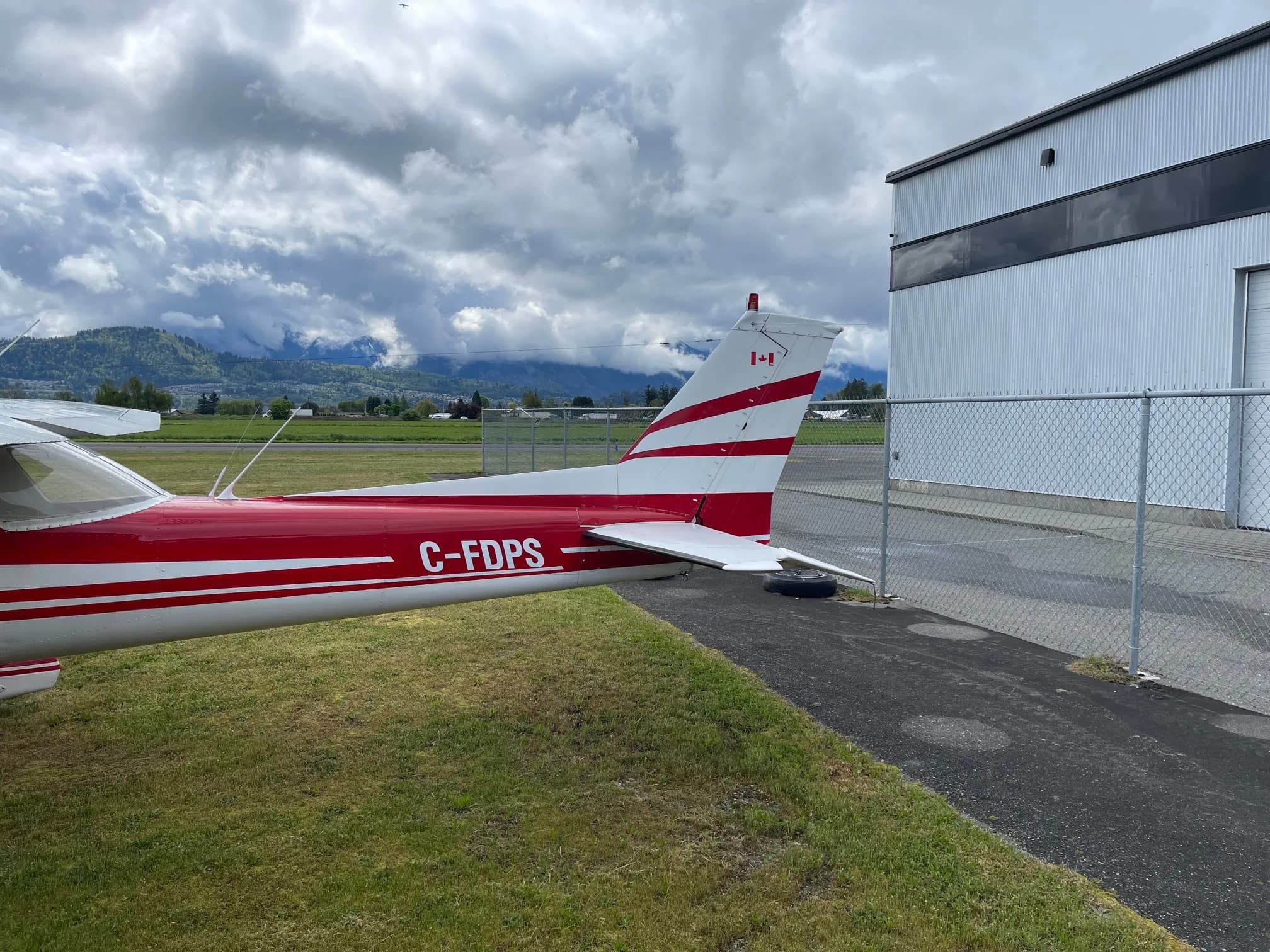 Tail section of C-FDPS Cessna aircraft with red and white paint scheme.