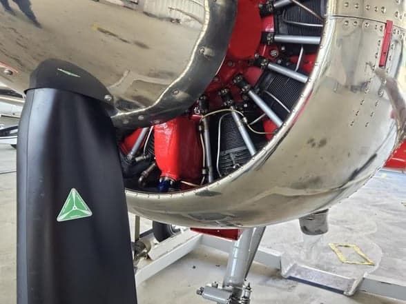 LY-EUG aircraft engine and propeller from a front view.