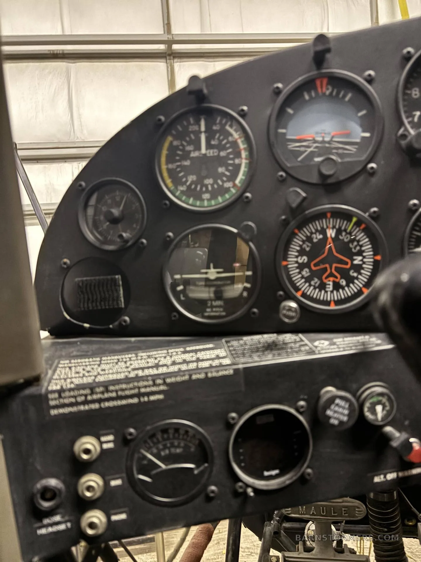 A close-up view of an aircraft's instrument panel with various gauges and controls.