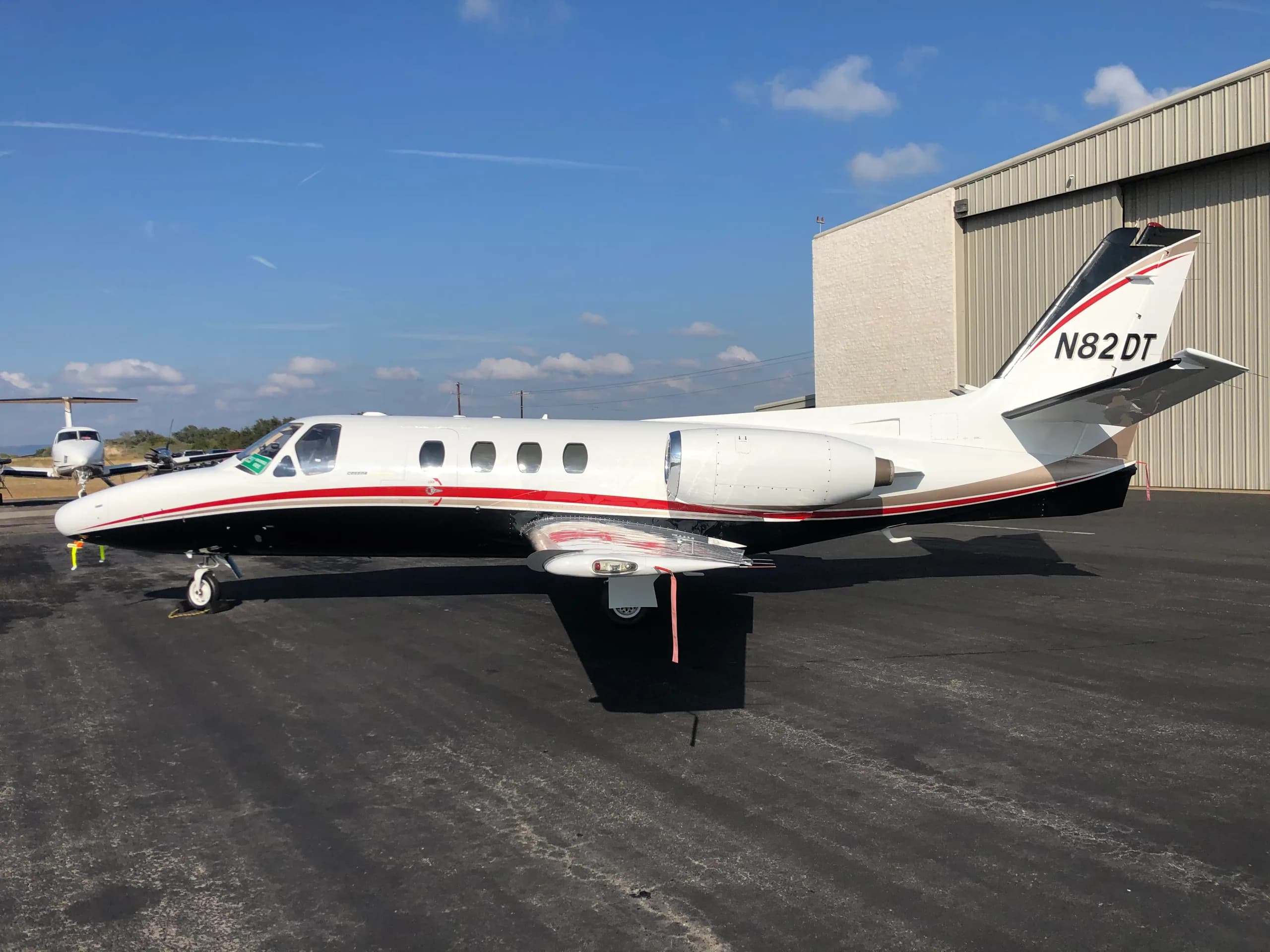 N82DT Cessna Citation parked on the tarmac in front of a hangar.