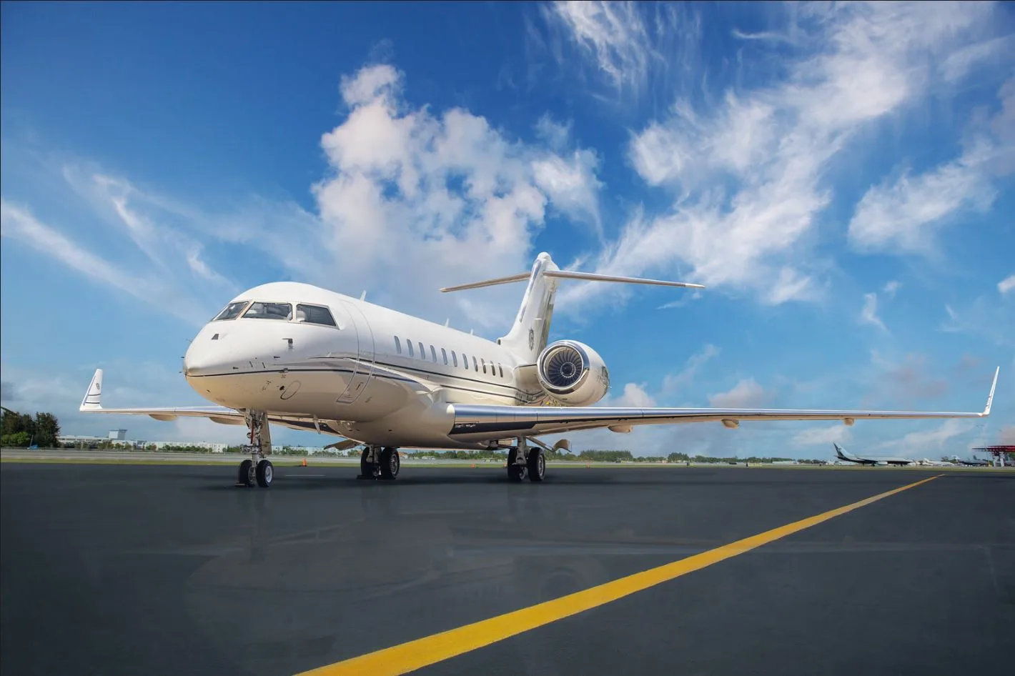 A white private jet parked on the tarmac.