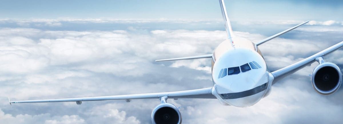 Red biplane in flight.