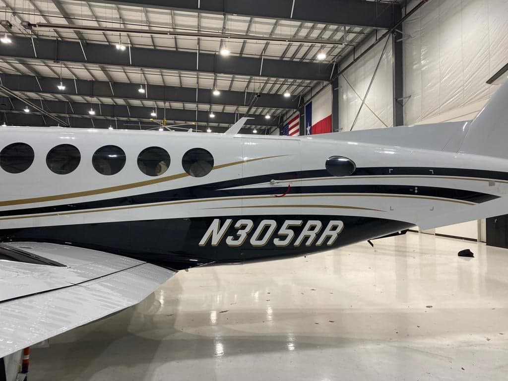 Close up of the tail section of a Beechcraft King Air 350 showing the tail number N305RR.