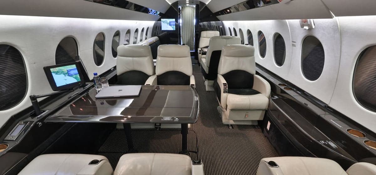 View of the aircraft interior showing seating and tables.