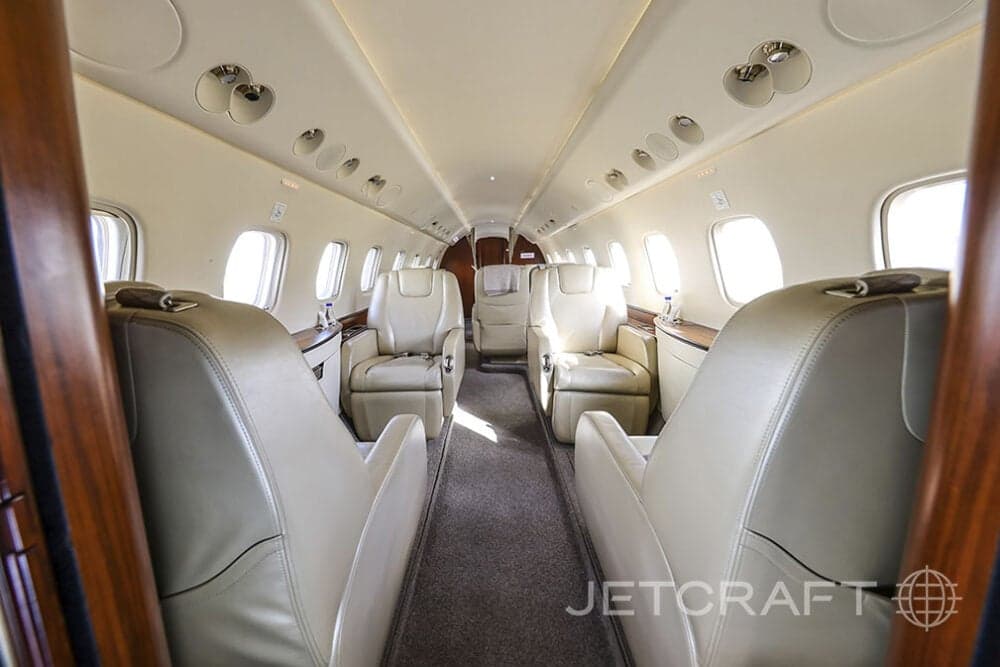 Forward view of the aircraft cabin with leather seats.