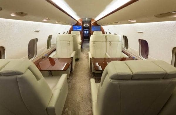 The interior of the Bombardier Challenger 300 features comfortable seating and luxurious amenities.
