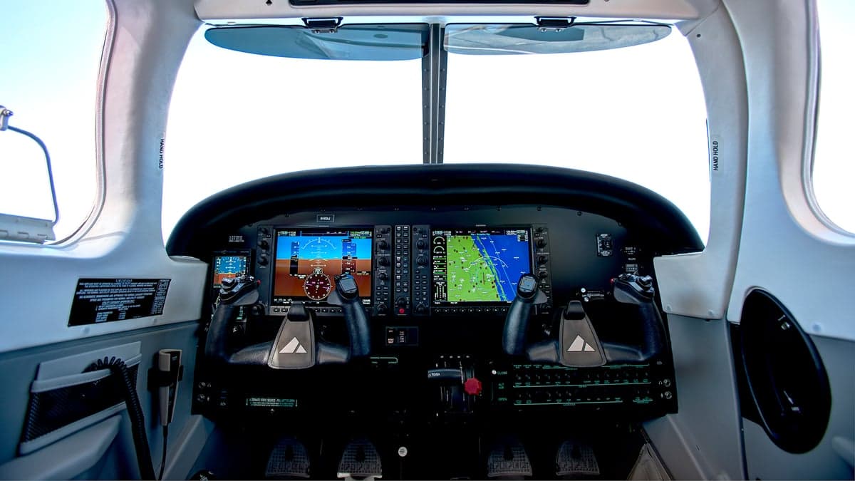 Aircraft cockpit featuring a modern glass panel display.