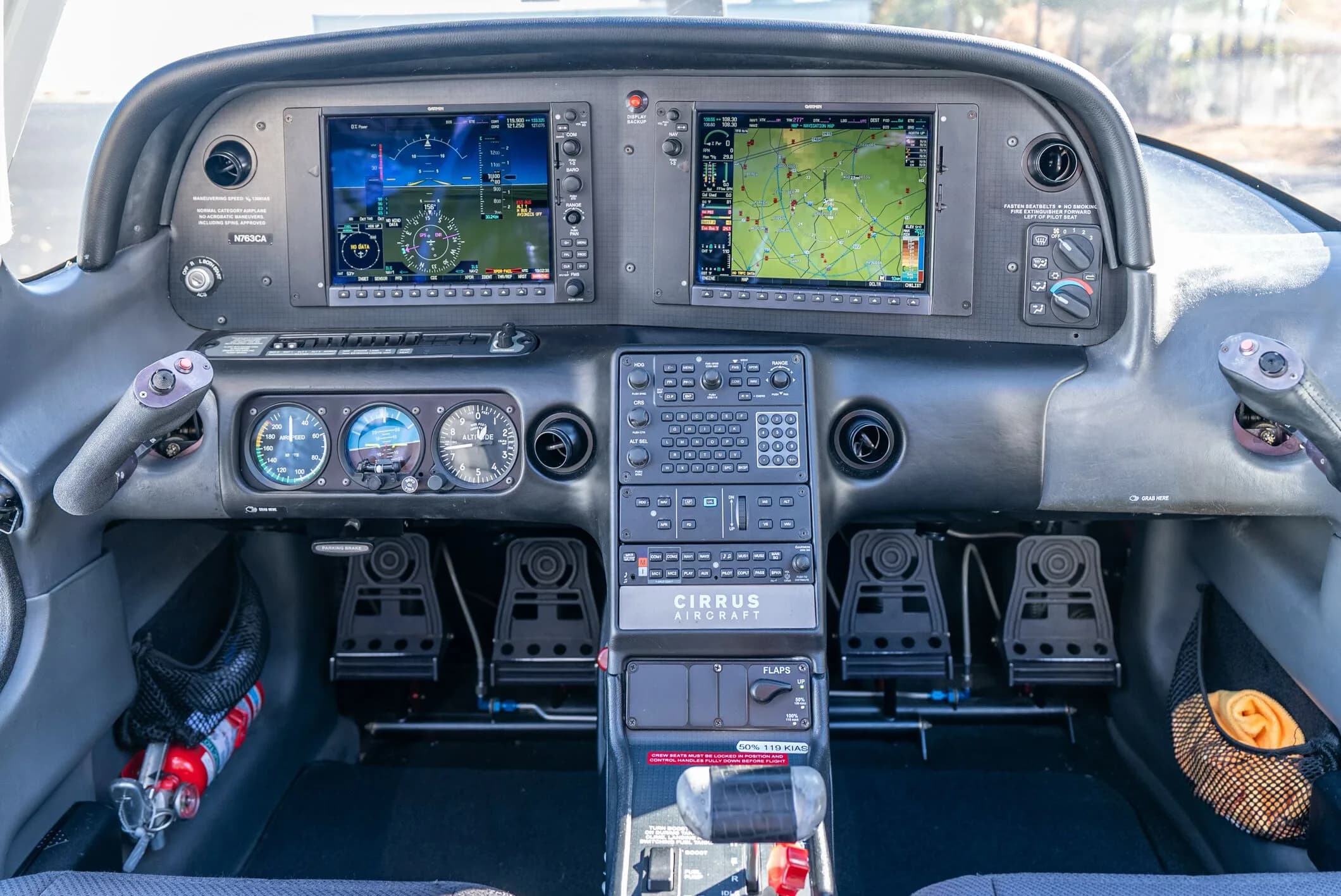A detailed view of the Cirrus SR20 cockpit shows the instrument panel with dual Garmin displays and controls.