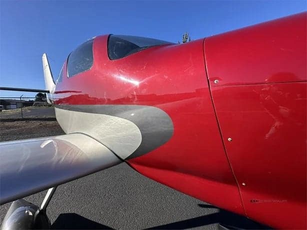 Close-up of the front of the red and silver LX7 aircraft.