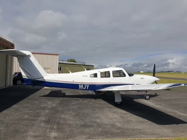 Piper Archer II on the tarmac with a white and blue paint scheme.