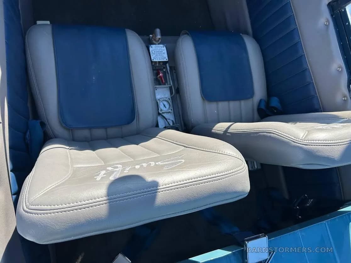 The interior of the aircraft, showing two light gray seats with blue accents and 'Swift' embroidered on one seat.
