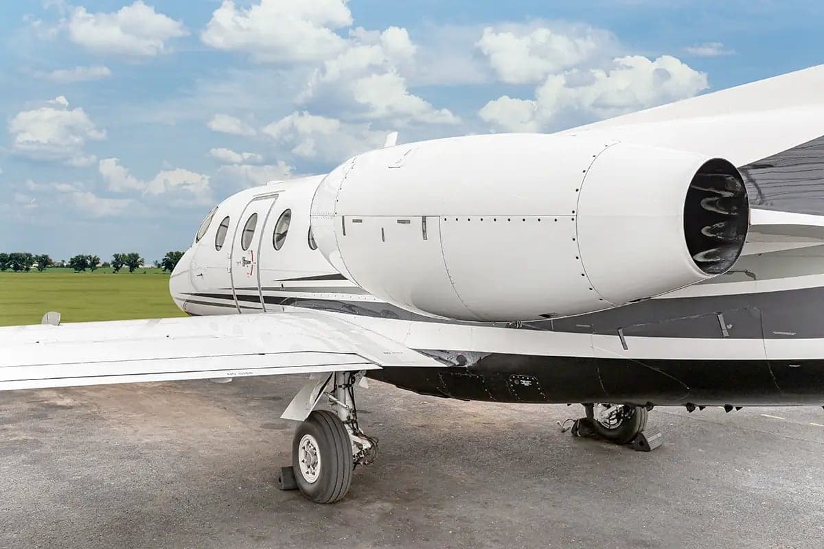 Close-up of the engine and fuselage of the Nextant 400XT aircraft with registration OK-ESC.