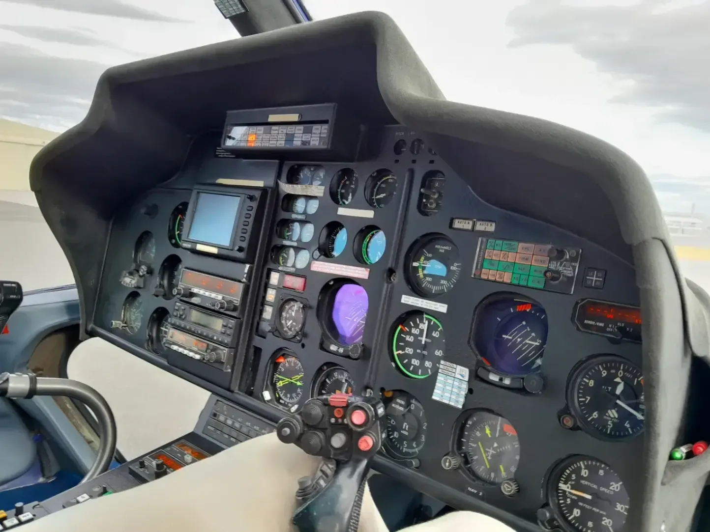 Close-up of the helicopter's instrument panel and controls.