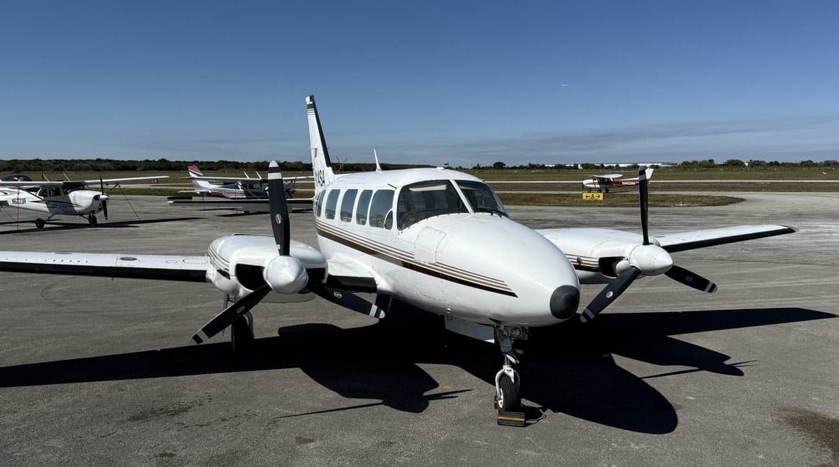 Front view of the twin-engine aircraft N114SA on the tarmac.