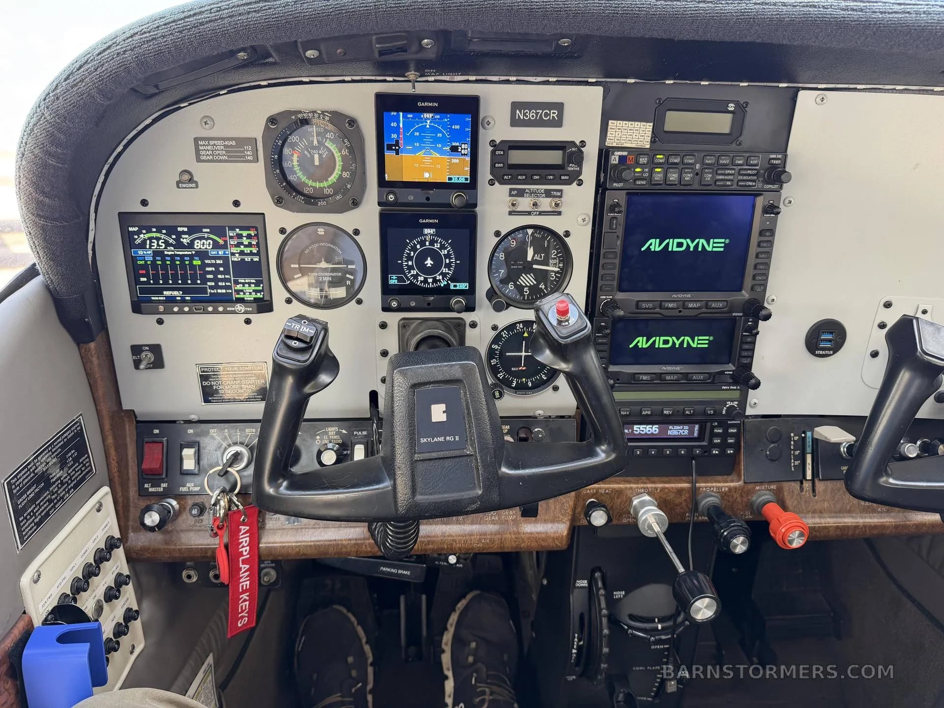 The cockpit of a Cessna 182 Skylane (N367CR) with a modern glass panel and traditional gauges.