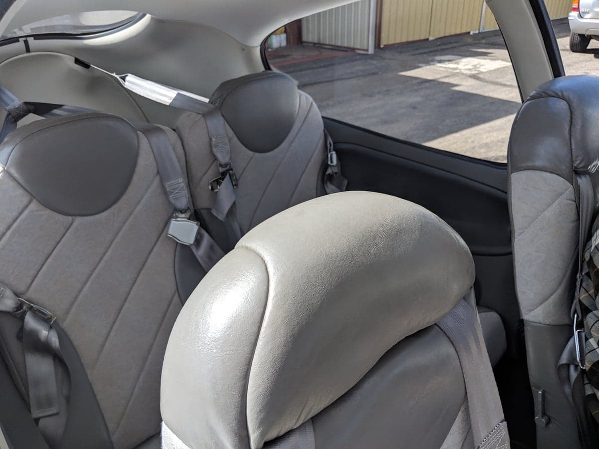 A view of the gray leather and fabric passenger seats in the cabin of a Cirrus SR20 aircraft.