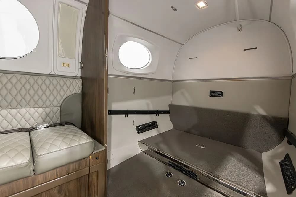Interior view of the King Air aircraft showing seating and storage.
