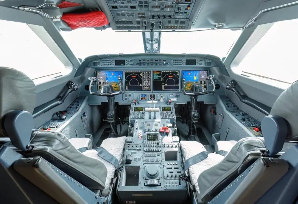View of the aircraft cockpit with instrument panel and seats.