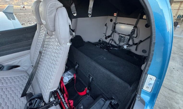 Rear interior of the Diamond DA50 RG aircraft showing the seats and storage area.