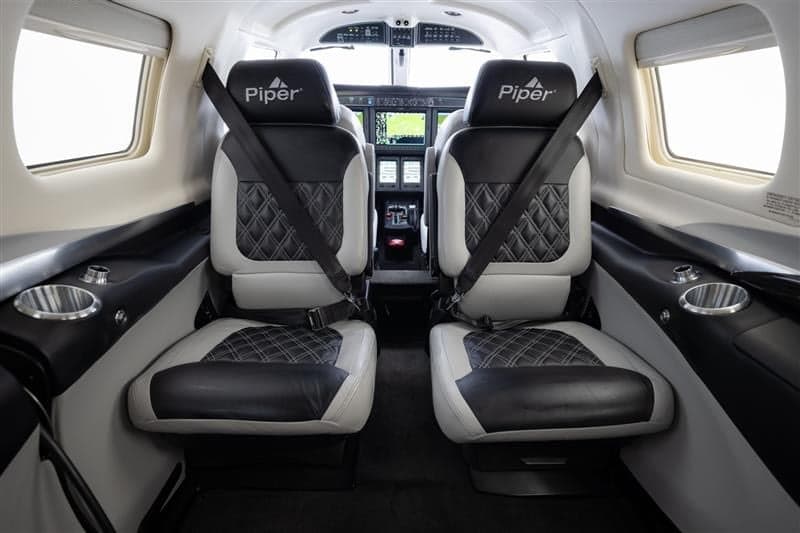 Interior view of a Piper M600 SLS aircraft showing the seats and cabin.