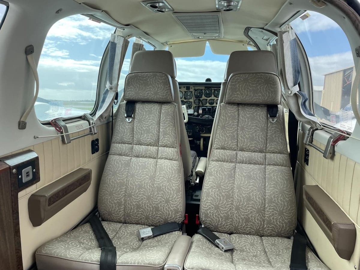 The aircraft's interior features two front seats with patterned upholstery.