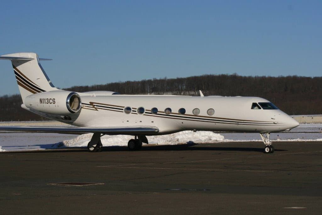 A Gulfstream GIV on the tarmac with snow on the ground.