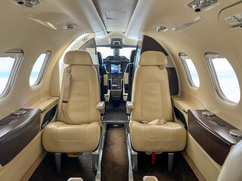 The Phenom 100 aircraft's cabin features comfortable seating and a spacious layout.