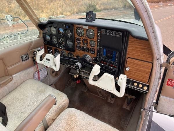 View of the cockpit with sheepskin seat covers and yokes.