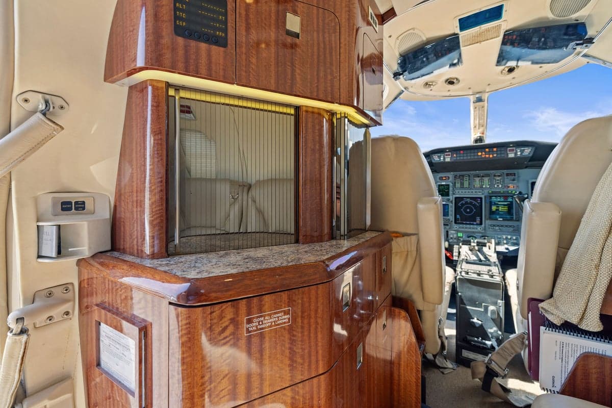 View of the aircraft interior showing a wooden cabinet and seating.
